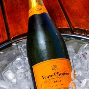 A bottle of Veuve Clicquot Brut Champagne chilling in ice, perfect for celebrations.
